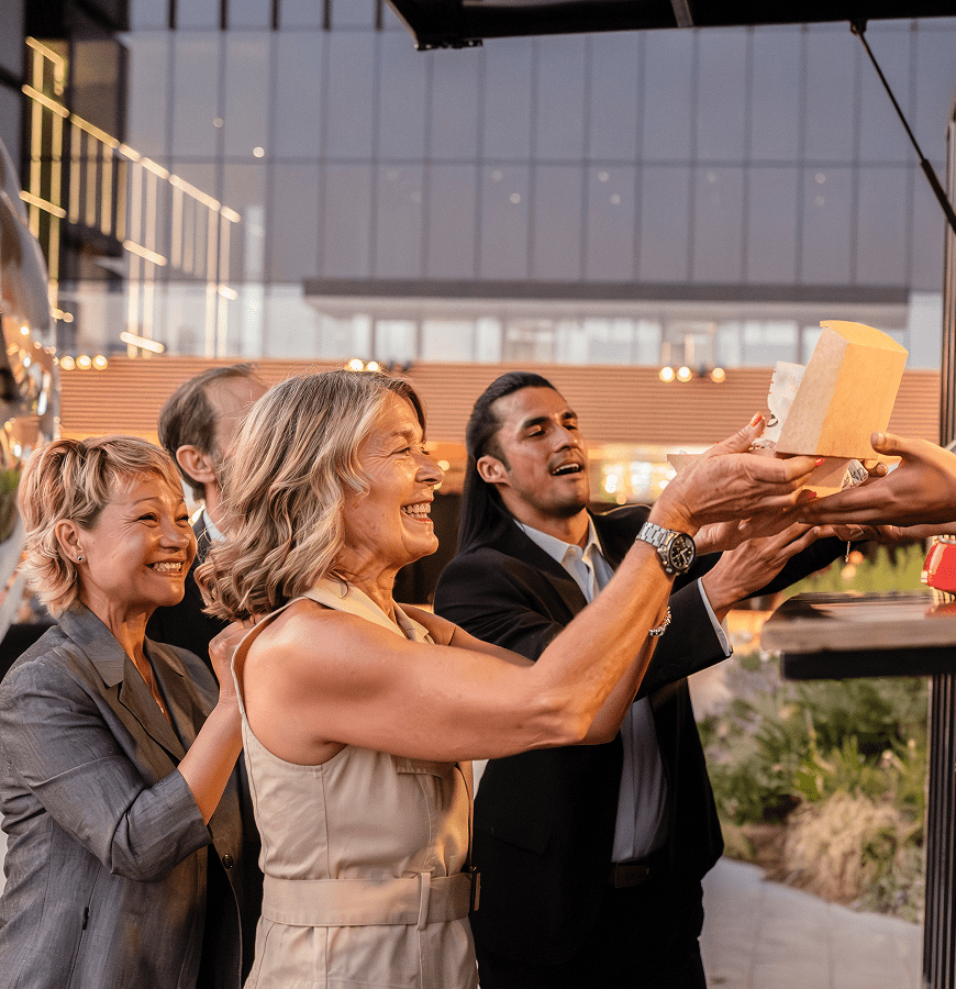 Group of people enjoying food truck service.