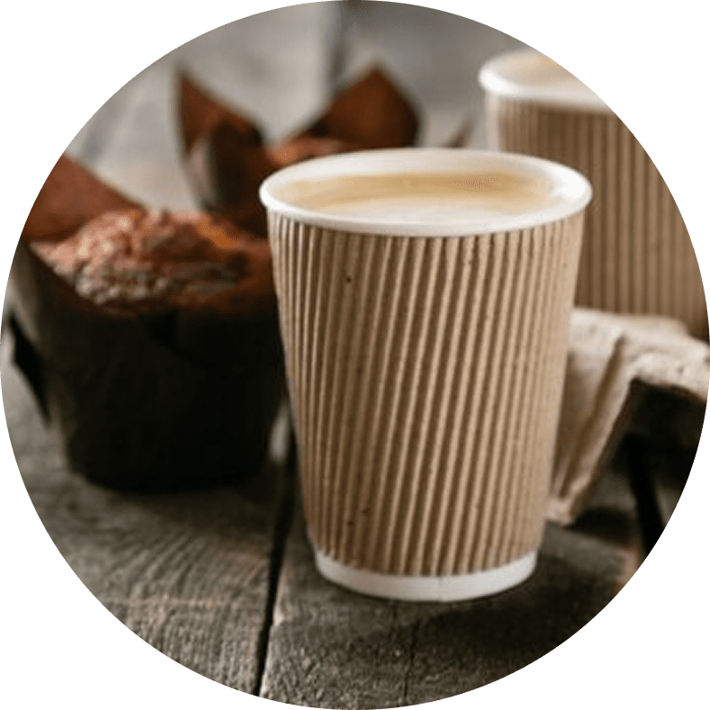 Coffee cup and muffin on wooden table.