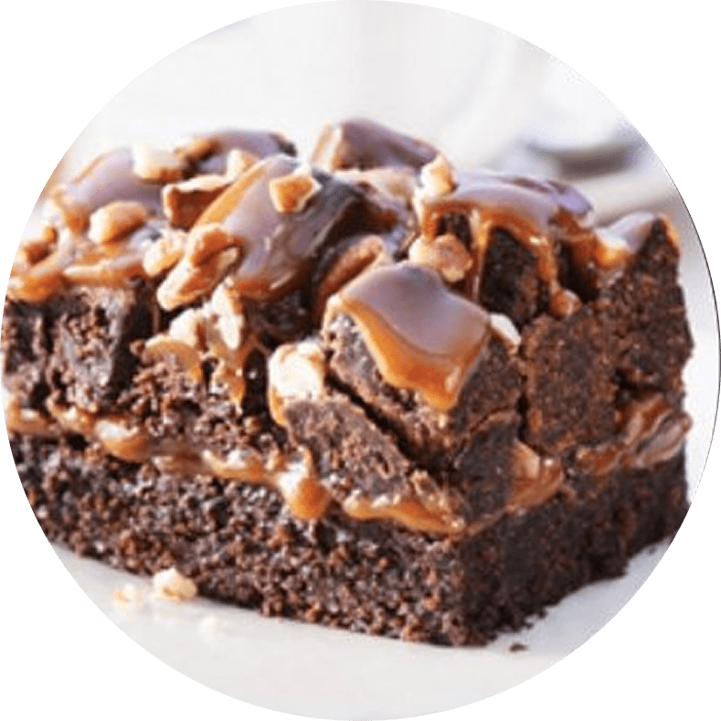 Chocolate brownie with caramel drizzle and nuts.