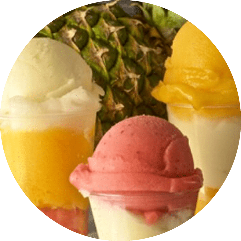 Colorful sorbet cups with fresh pineapple background.