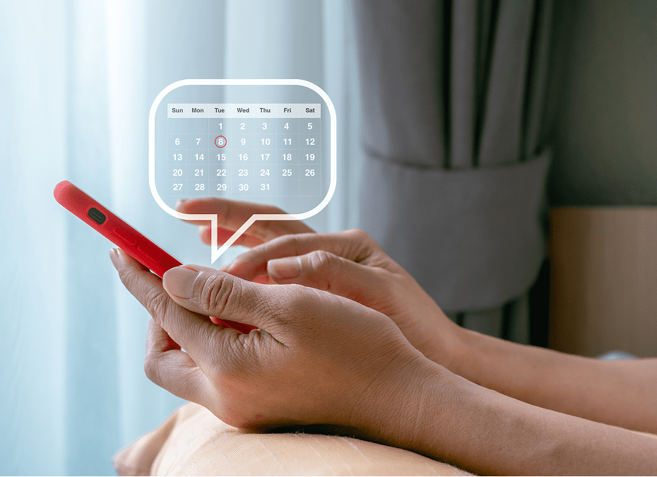 Person checking calendar on smartphone, scheduling events.